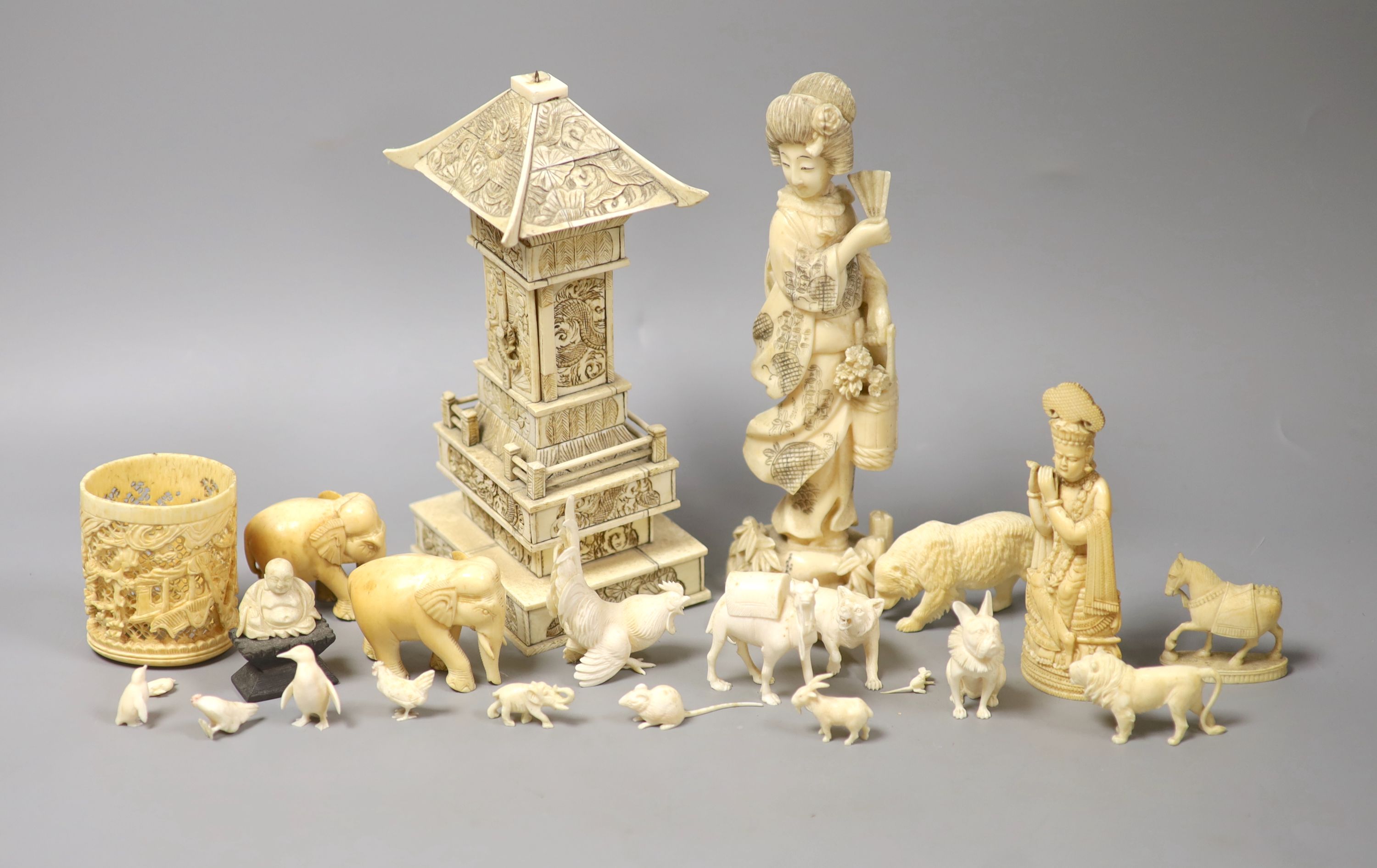 A Japanese Ivory model of a bijin, a similar model of a temple, various European Ivory models of animals and birds, an Indian Ivory figure et cetera, or late 19th or early 20th century